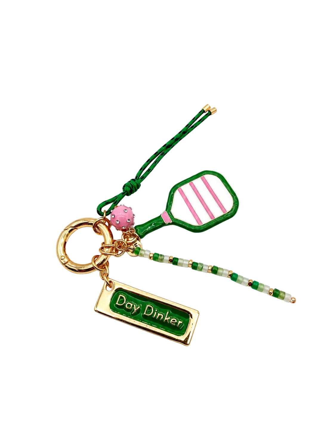 A novelty keychain featuring a green and pink tennis racket charm, a green beaded strap, a pink tennis ball accent, and a gold-tone rectangular charm engraved with 'Day Dinker'.